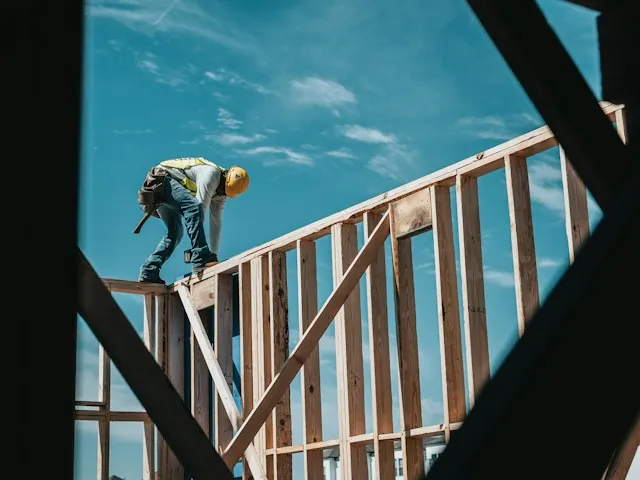 a builder working on the wood framing of a new home