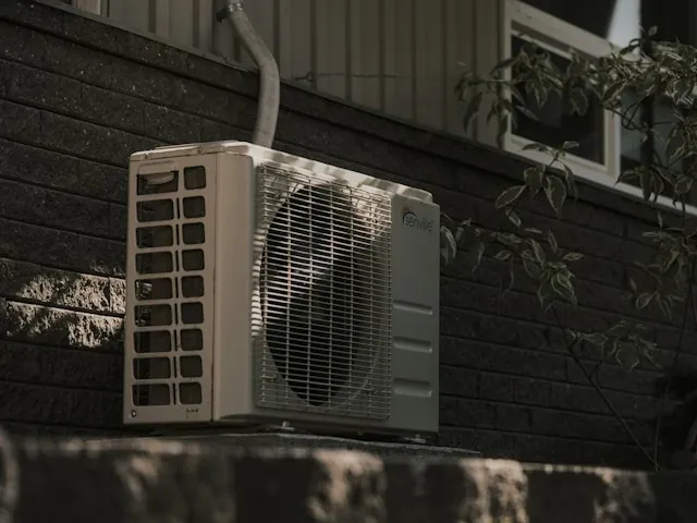 an outdoor air conditioning unit beside a home
