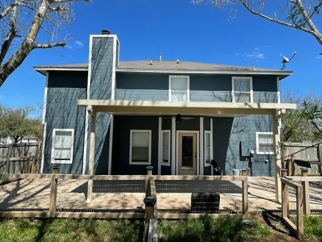 a two-story home with new blue siding